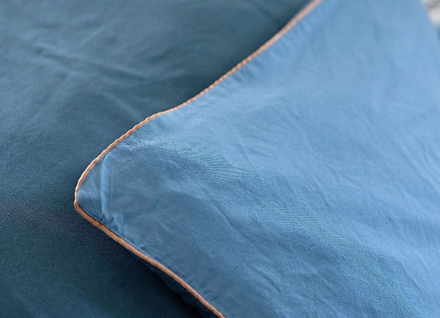 Close-up of blue bedding with a textured surface